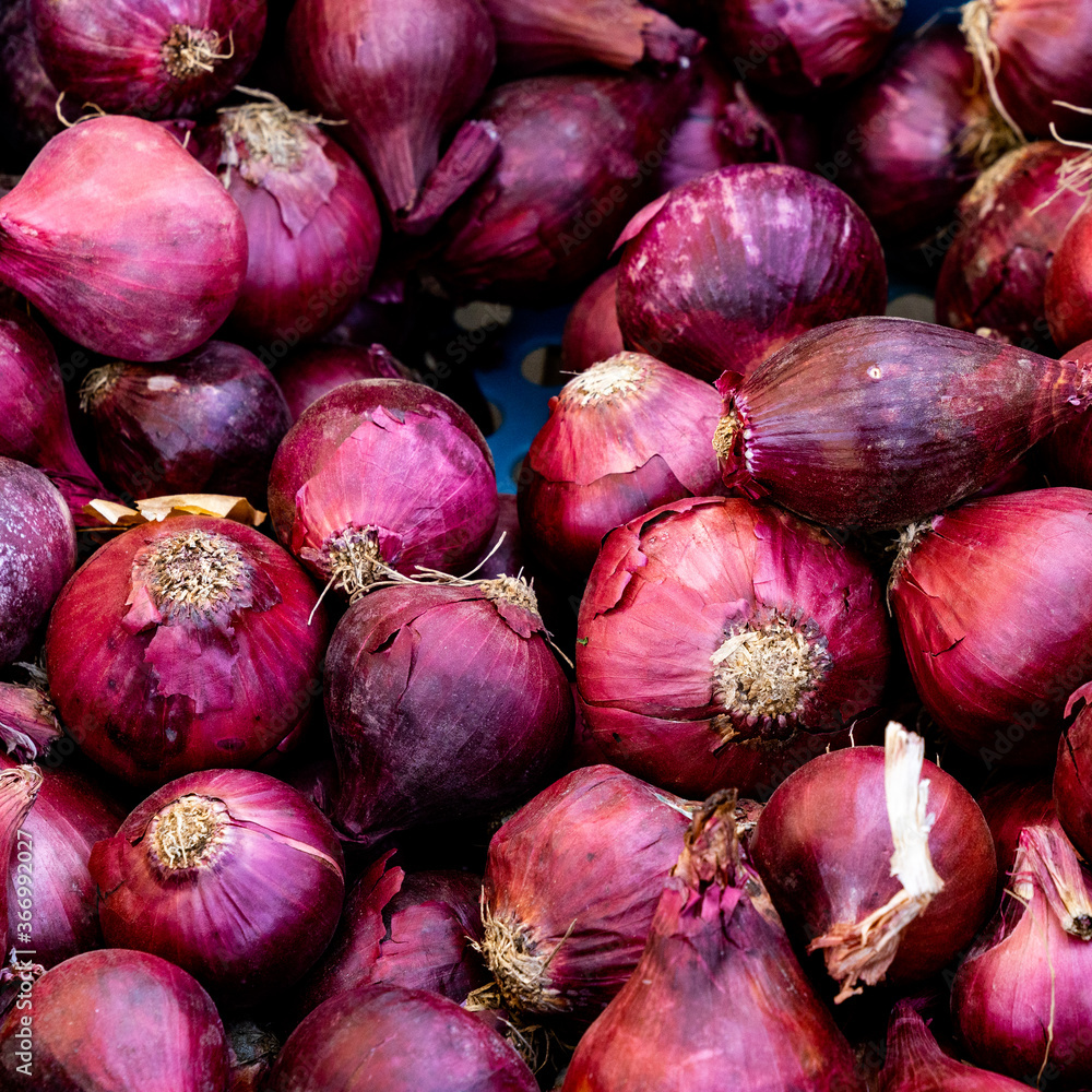 close up view of many organic red onions close up view of many organic red onions
