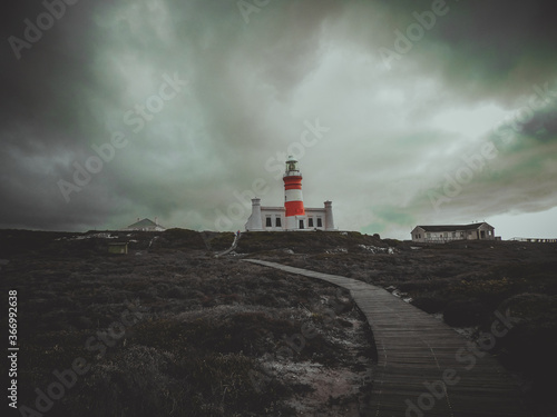 Cape Agulhas Lighthouse situated at the southern most tip of Africa with a dramatic skyscape