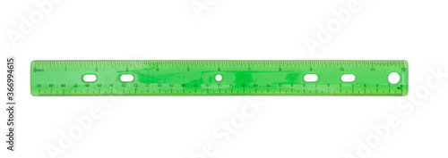 Green plastic 12-inch ruler isolated on white