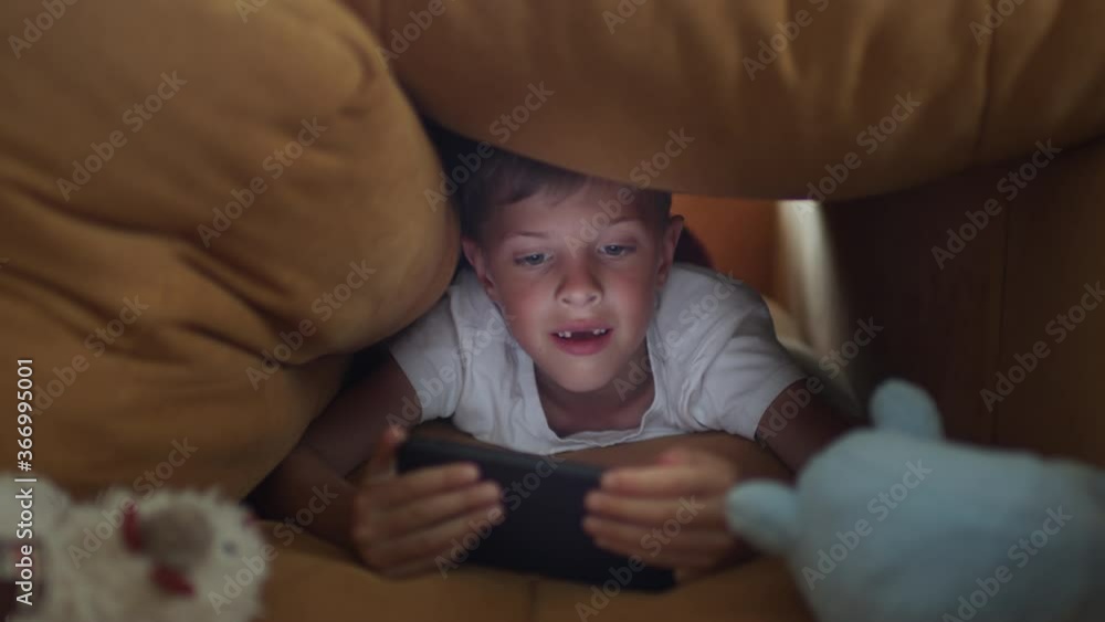 Boy Emotionally Playing Game On Mobile Phone. Boy Emotionally Playing Game On Mobile Phone.