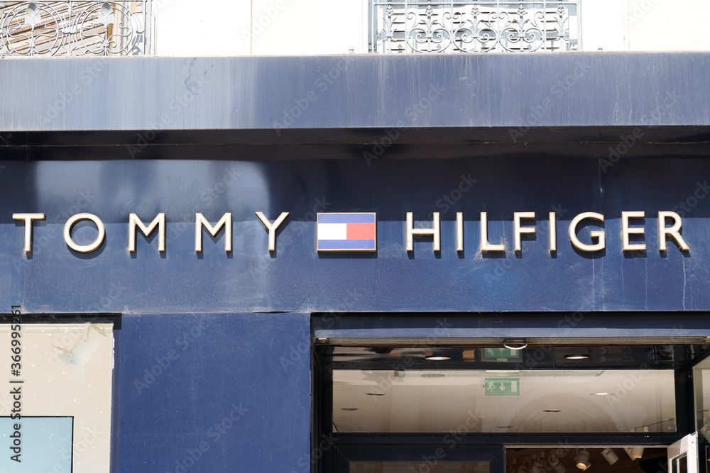 Tommy Hilfiger sign and text logo store of American clothing company shop  Stock Photo | Adobe Stock
