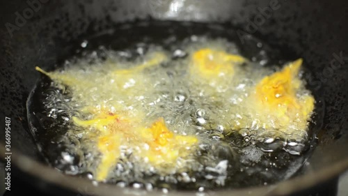Indian kanda bhaji frying in hot oil, India street food. photo