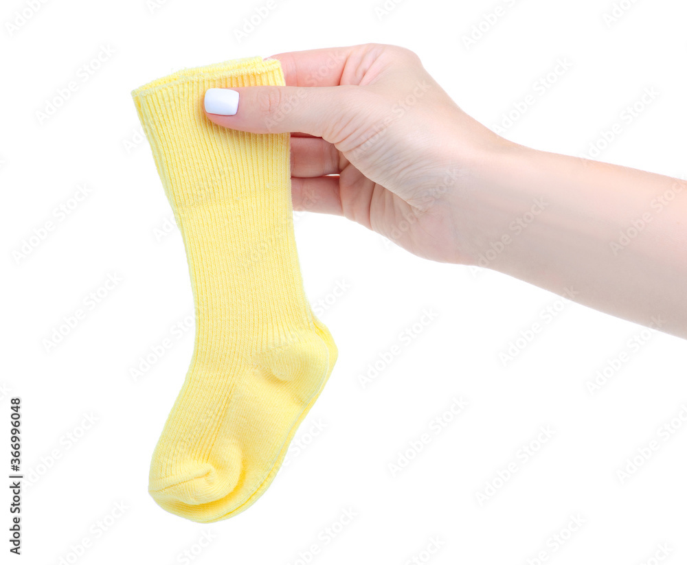 Yellow baby socks for newborn in hand on white baclground isolation Yellow baby socks for newborn in hand on white baclground isolation