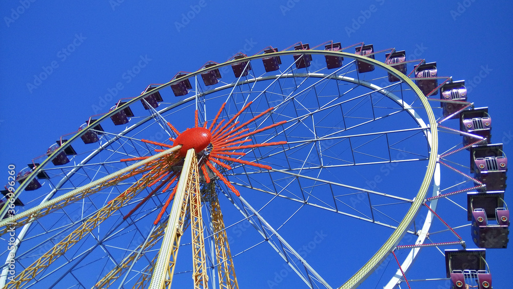 Ferris wheel against the blue sky