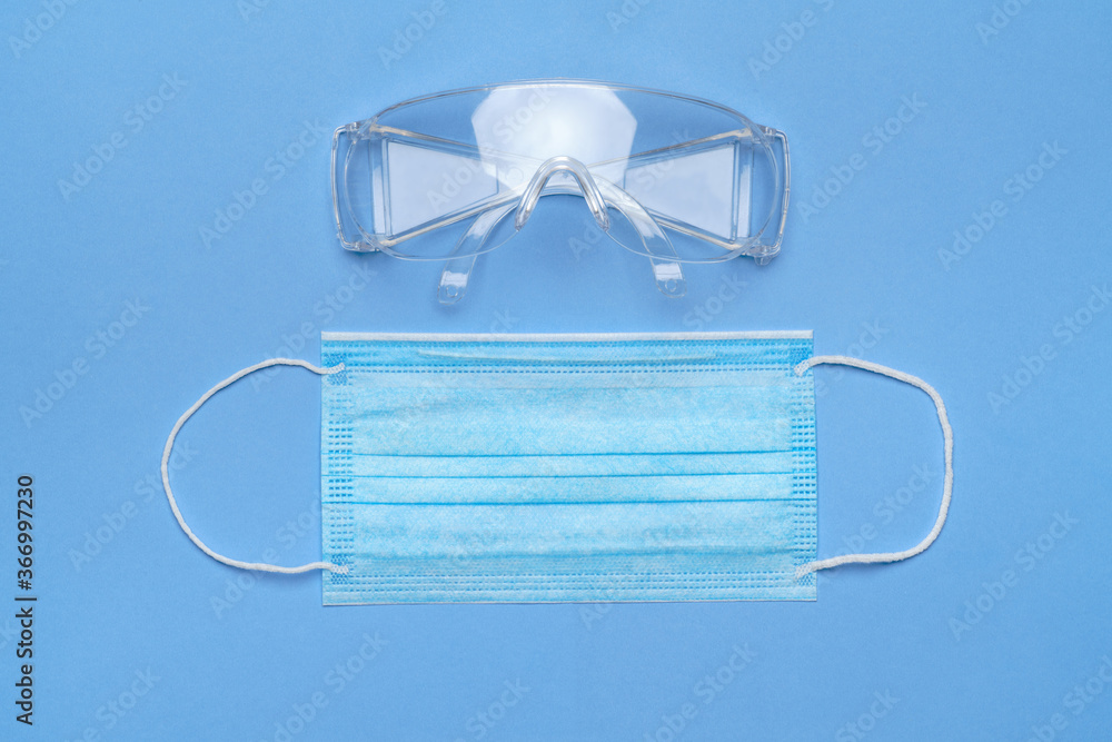 mask and safety glasses for personal protection on blue baclground mask and safety glasses for personal protection on blue baclground