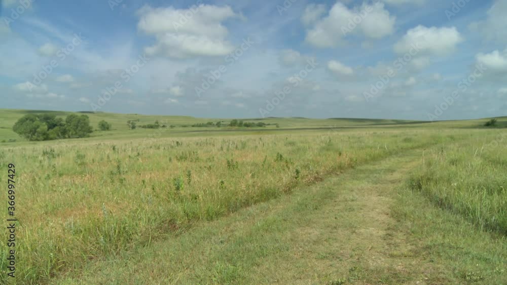 wide open wild Kansas prairie hills with trail in the tall grass wide open wild Kansas prairie hills with trail in the tall grass