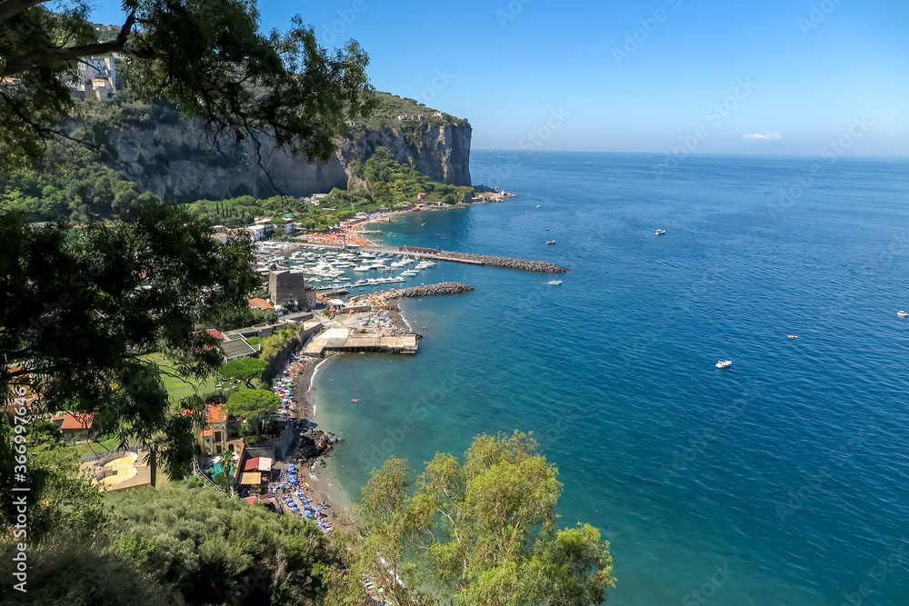 Great cliff on the shores of the Mediterranean Sea, with houses, beaches and boats, Sorrento commune, Naples province, Italy