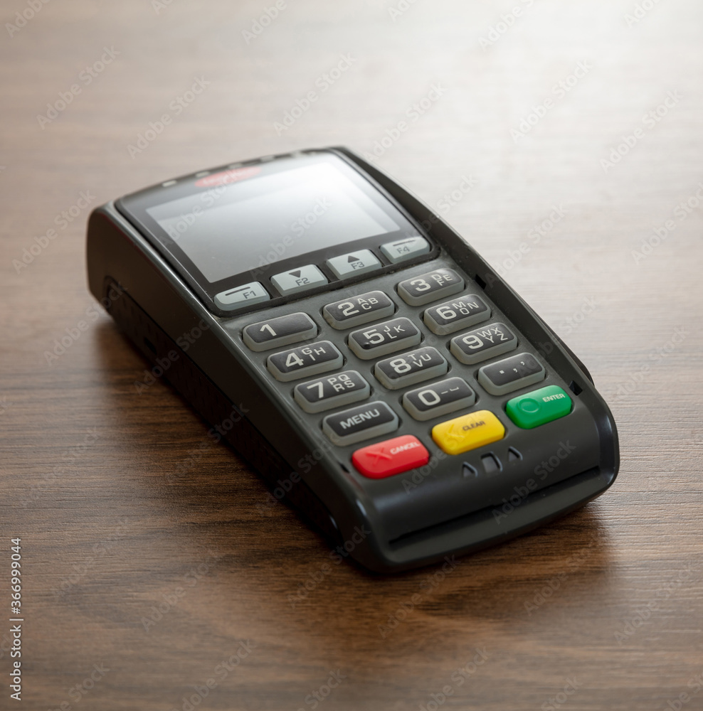 Payment machine, POS terminal on wooden background. Payment machine, POS terminal on wooden background.
