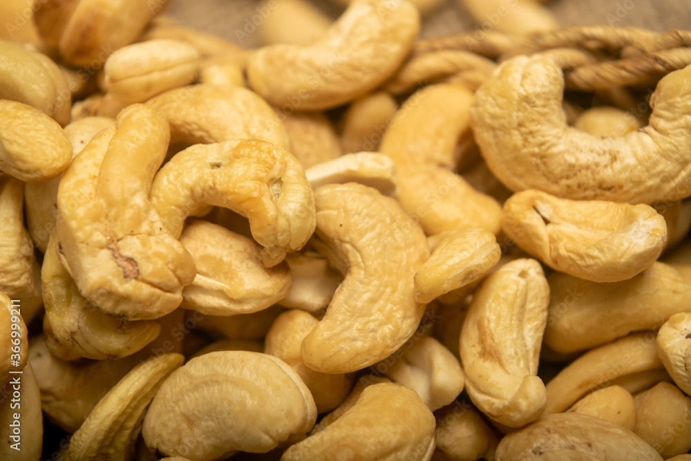 Cashew nuts scattered surface texture. Close up. Cashew nuts scattered surface texture. Close up.