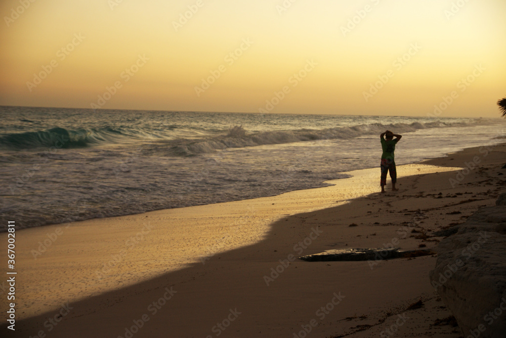 at sunset on a caribbean beach in summer