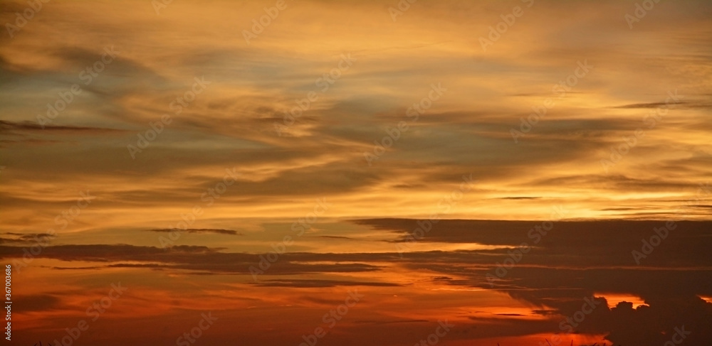 Beautiful dramatic sunset with orange sky and awesome golden reflection. Amazing summer sunset view.