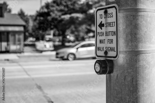 Push button at cross walk busy street intersection in a city photo