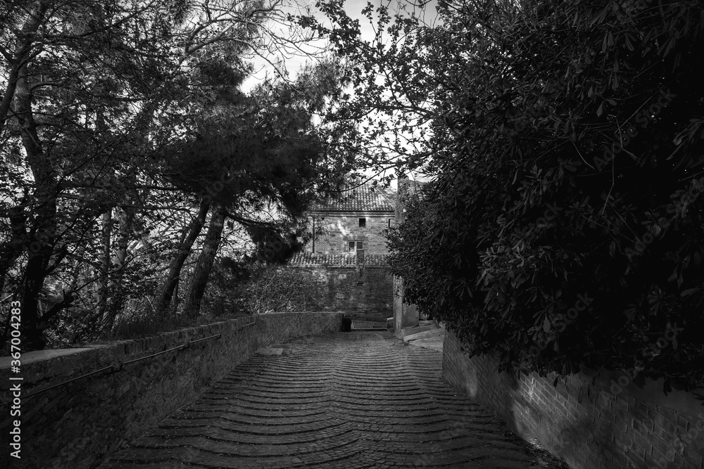 Fototapeta premium a steep descent leads from the old medieval village to the modern city
