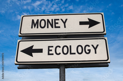 Money vs ecology. White two street signs with arrow on metal pole with word. Directional road. Crossroads Road Sign, Two Arrow. Blue sky background. Two way road sign with text.