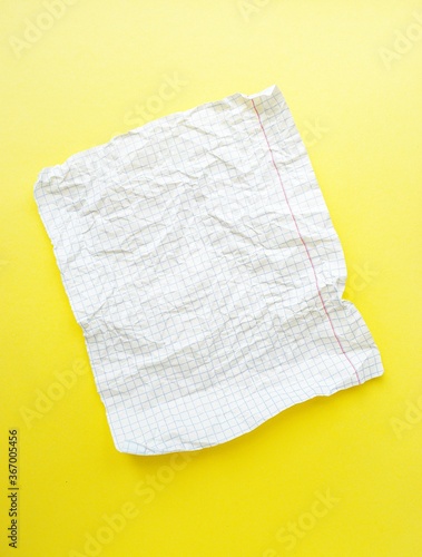 A white sheet of paper in a cage on a bright yellow background.