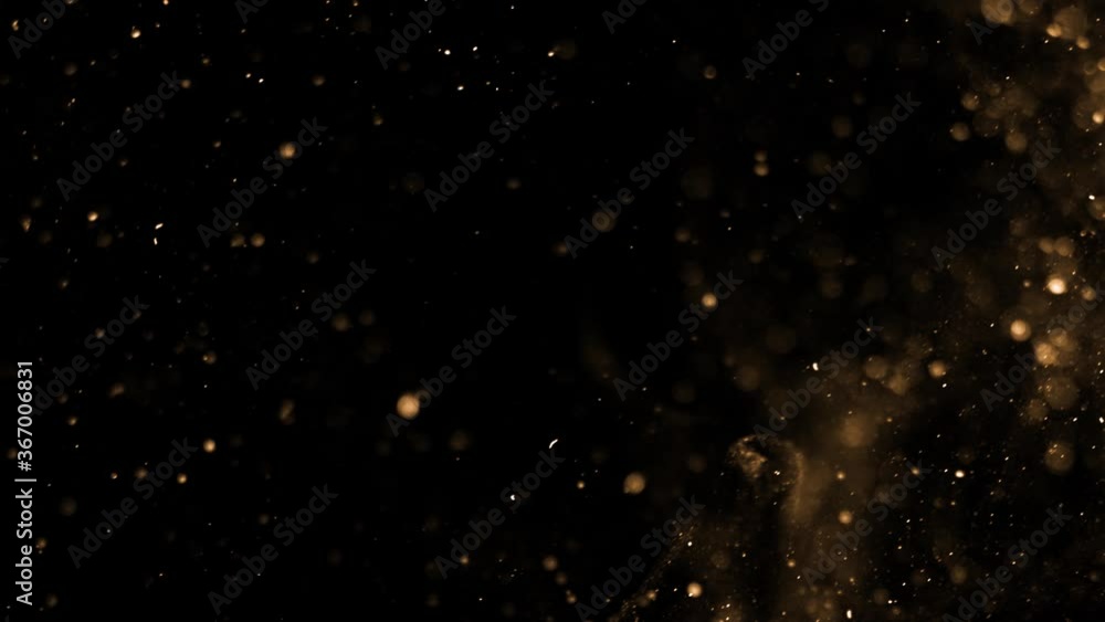 Gold dust particles fly in slow motion in the air lingering slowly. Dust Particles Background Bokeh Lights Background on Black Background 4k Footage Snow Particles Background. Gold dust particles fly in slow motion in the air lingering slowly. Dust Particles Background Bokeh Lights Background on Black Background 4k Footage Snow Particles Background.