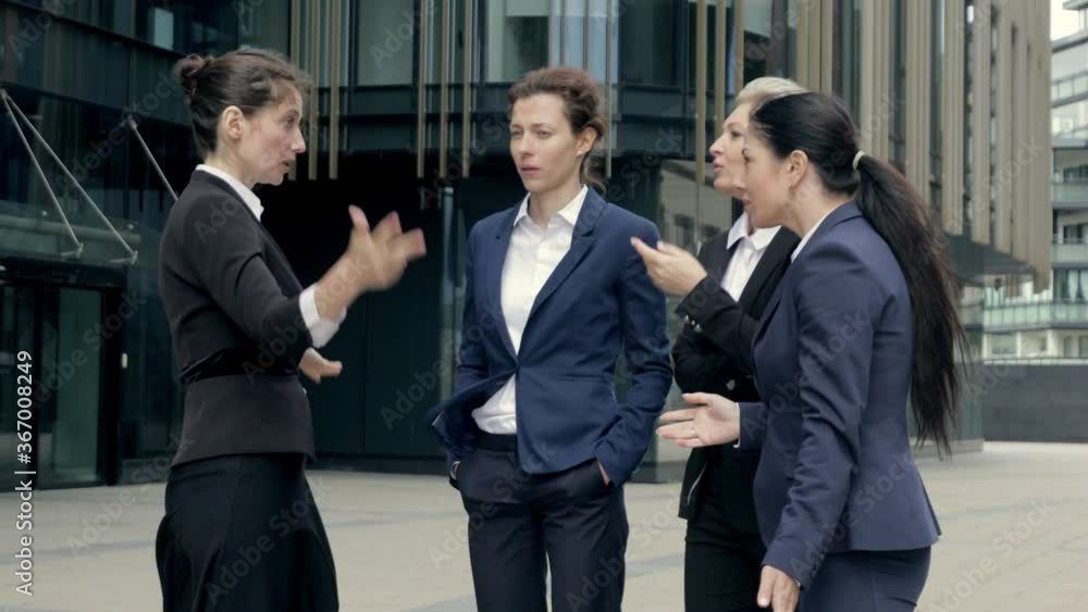 Middle-eged speaker coach female boss gives explanation teaching business sales team at group meeting, woman business trainer presenter speaking at conference break in office center Middle-eged speaker coach female boss gives explanation teaching business sales team at group meeting, woman business trainer presenter speaking at conference break in office center