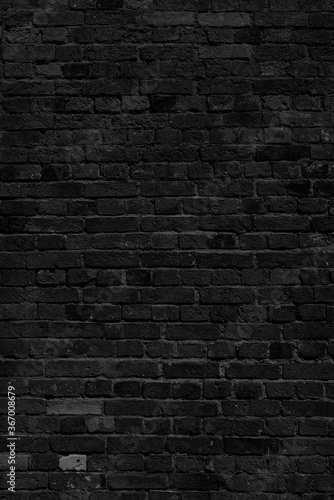 Black brick wall. Loft interior design. Black paint of the facade.