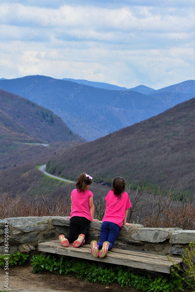 Girls on Mountain Top looking in Distance Girls on Mountain Top looking in Distance