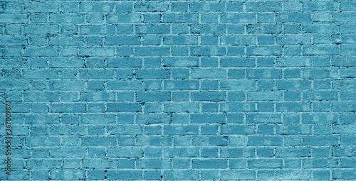 Blue brick wall. Loft interior design. Blue paint of the facade. Architectural background.