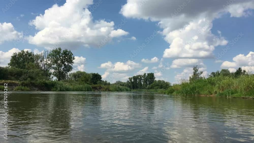 time lapse of warta river during a beautiful day of summer with white clouds moving fast over the water time lapse of warta river during a beautiful day of summer with white clouds moving fast over the water