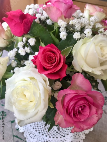 Beautiful festive flower bouquet arrangement of a bunch of fresh pink and white roses celebrating the happy occasion of a birthday or anniversary at home