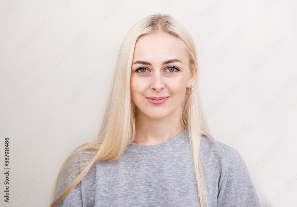 Pretty smiling joyfully female with fair hair, dressed casually, looking with satisfaction at camera, being happy. Studio shot of good-looking beautiful woman Pretty smiling joyfully female with fair hair, dressed casually, looking with satisfaction at camera, being happy. Studio shot of good-looking beautiful woman