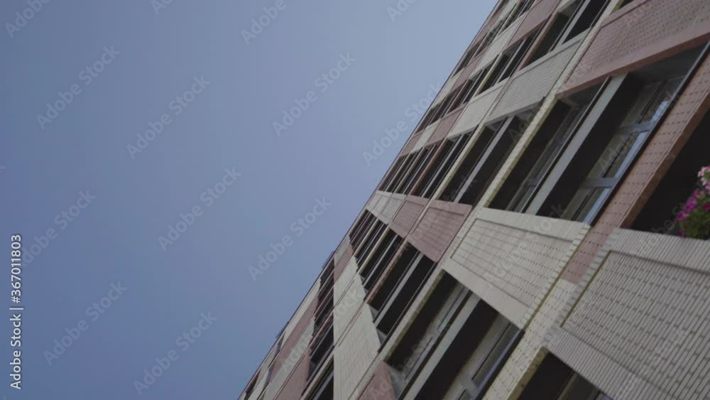 the facade of brick high-rise apartment buildings with stained glass windows. the facade of brick high-rise apartment buildings with stained glass windows.