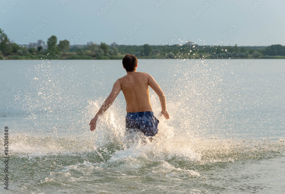 Young man running on the beach