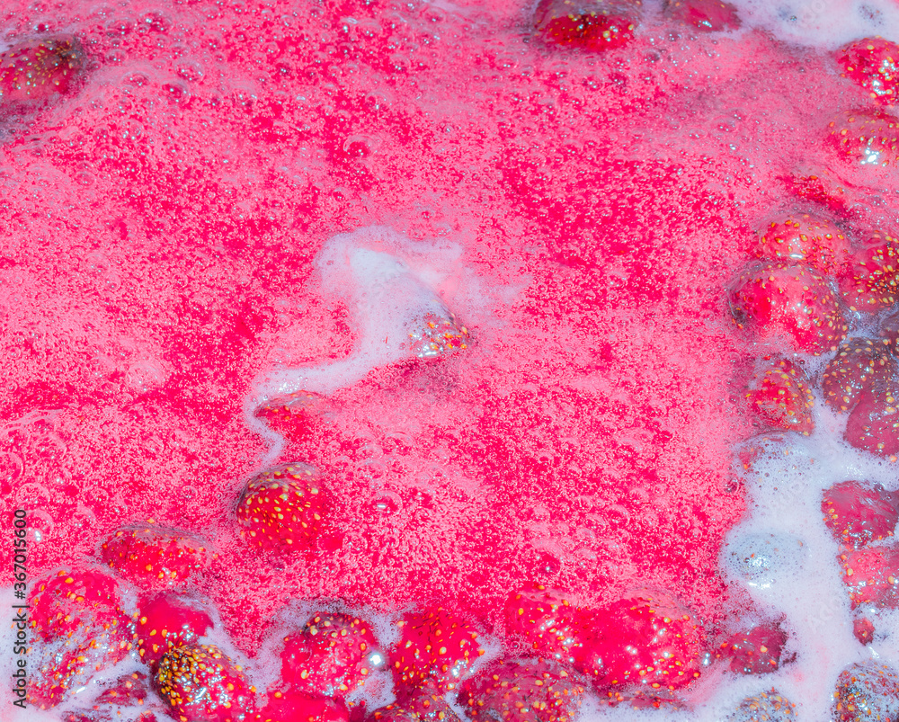 Fototapeta premium froth on strawberry jam, top view