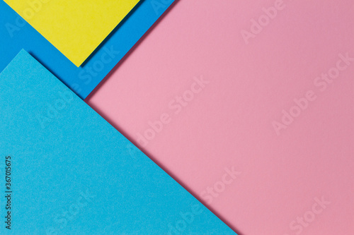 Abstract color papers geometry flat lay composition background with blue, yellow and pink color tones