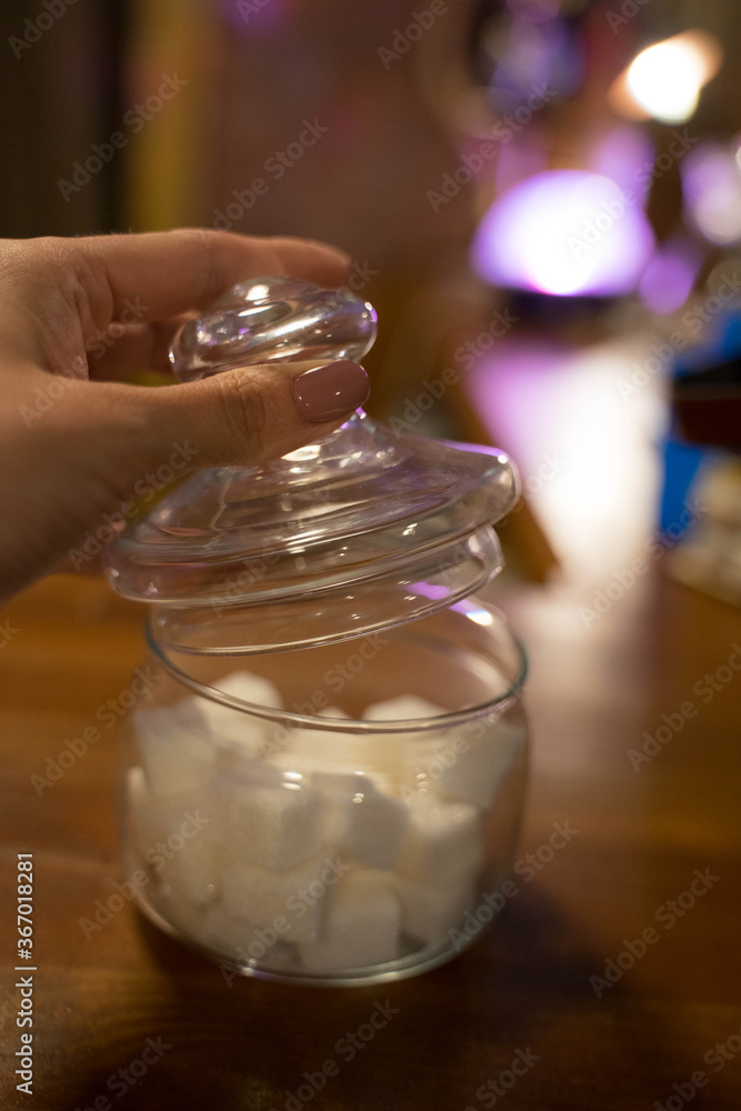 transparent glass jar with white sugar on the table transparent glass jar with white sugar on the table