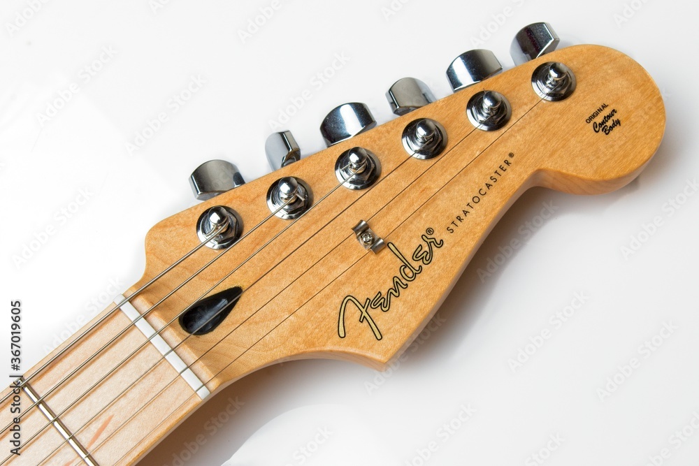 Fender Stratocaster guitar headstock with maple neck. Photos | Adobe Stock