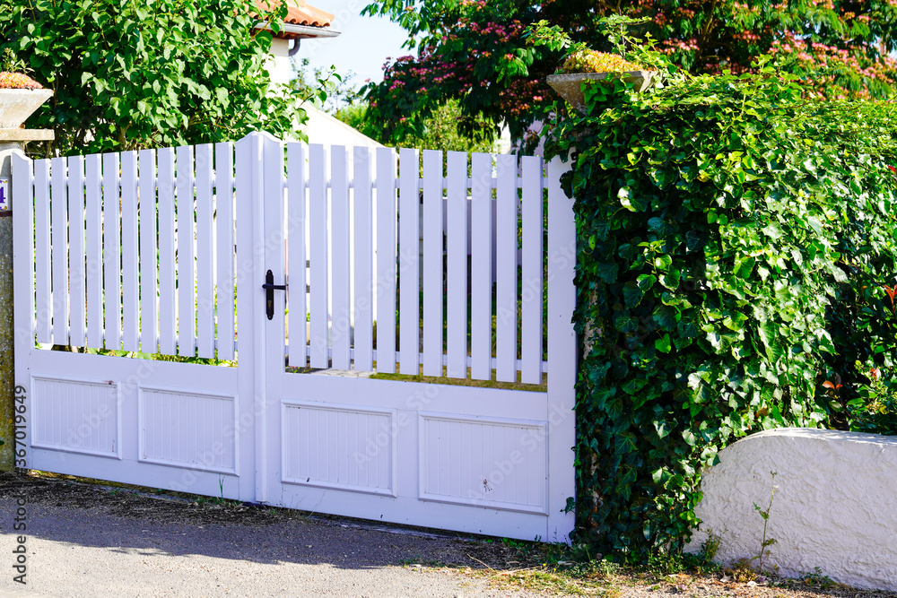 pvc plastic white gate portal of suburb house in street view pvc plastic white gate portal of suburb house in street view