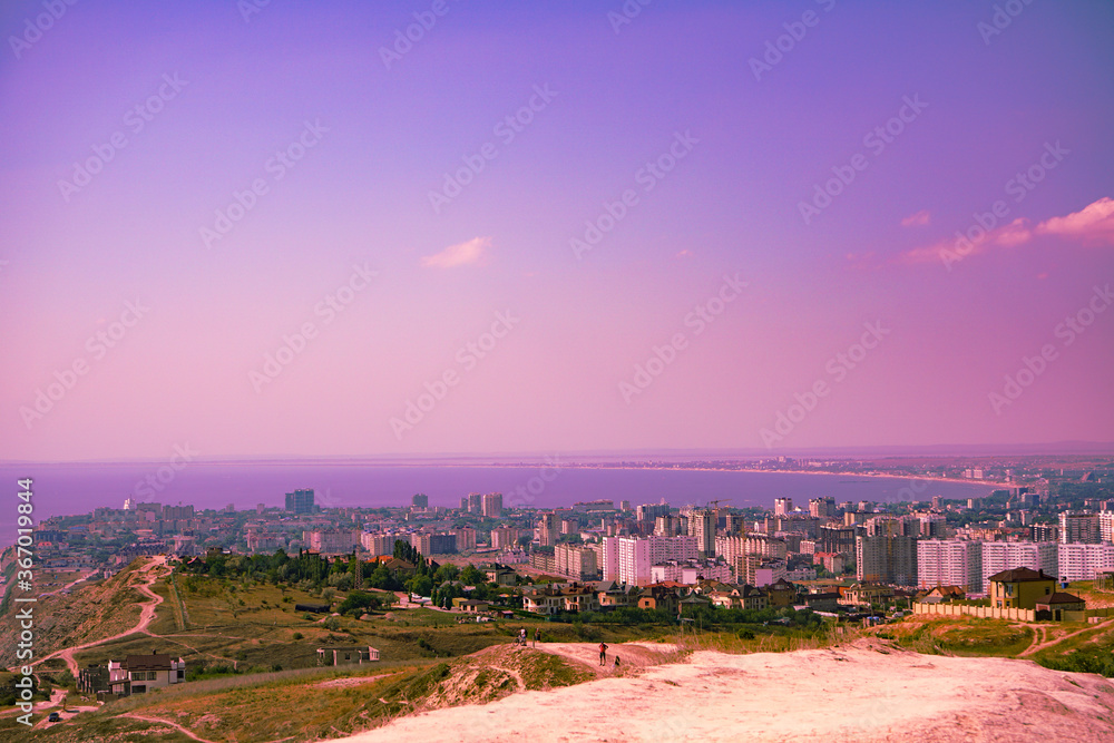 Fototapeta premium beautiful view of the city and the sea from the mountain at sunset and the sky in an unusual color