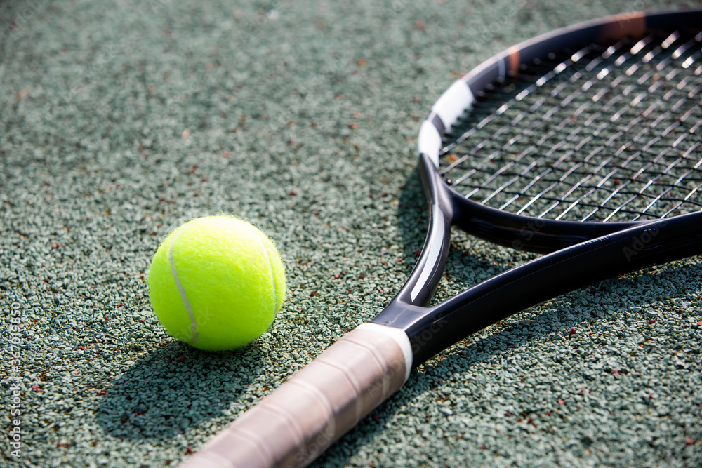 Close up of tennis racket and ball on a court, sport concept