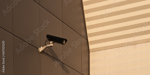 Surveillance camera on the outside wall of a building symbolizing state supervision