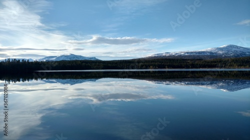 reflection of clouds and mountains in lake