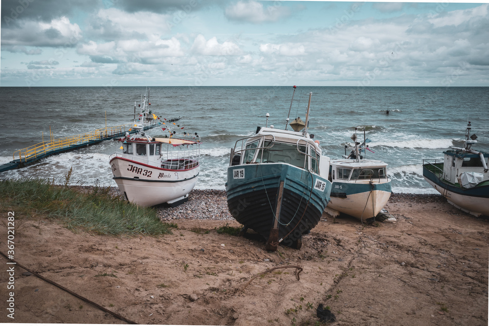 At Beach of Jaroslawiec in Poland fishing boats lie on the beach of the Baltic Sea At Beach of Jaroslawiec in Poland fishing boats lie on the beach of the Baltic Sea
