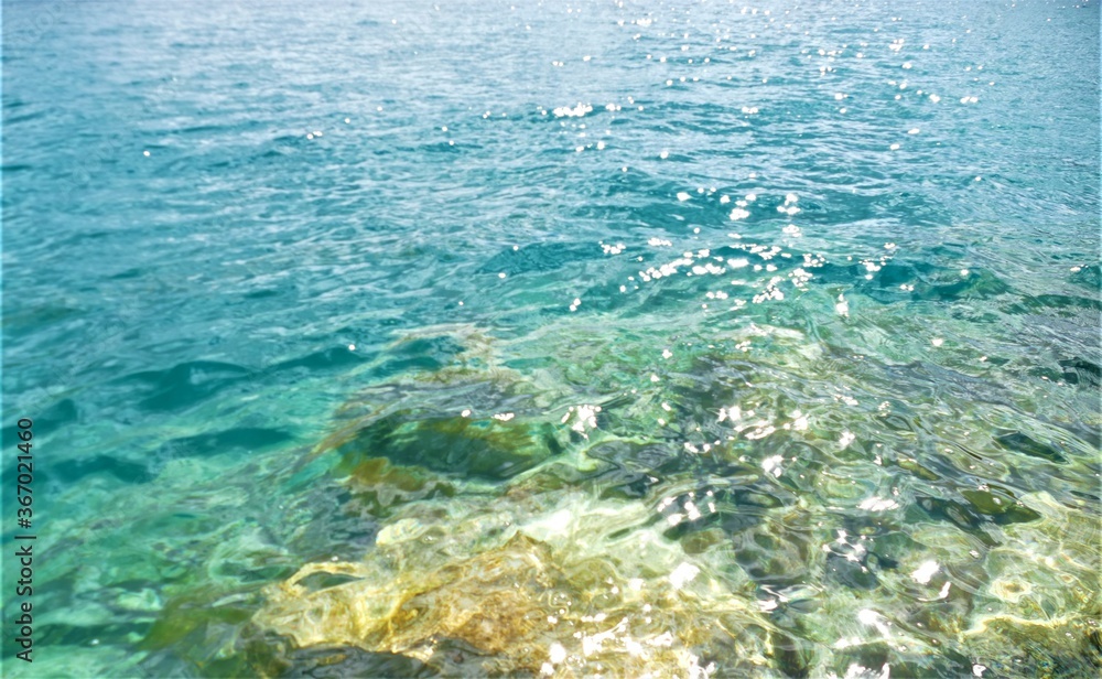 Clear blue sea water and stone background