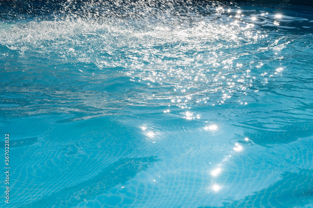 Splashing blue water in the pool as a background.