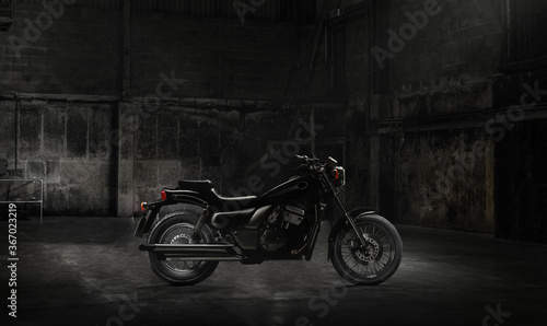Vintage motorcycle standing in a dark building in the rays of sunlight.