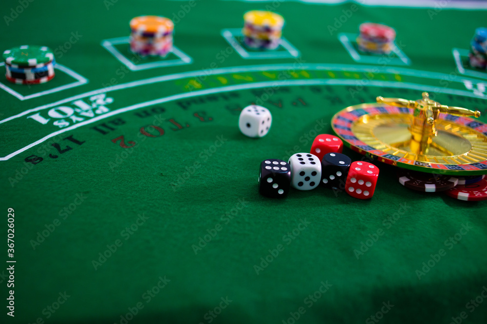 Casino equipment placed on the green floor for risky gambling for the people who want to get rich. Casino equipment placed on the green floor for risky gambling for the people who want to get rich.
