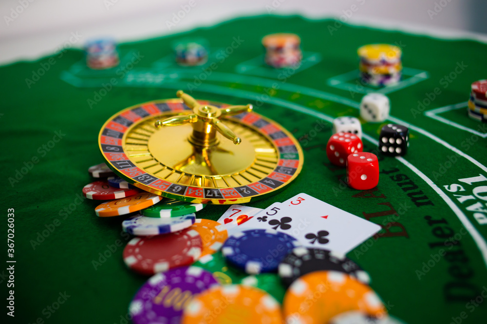 Casino equipment placed on the green floor for risky gambling for the people who want to get rich. Casino equipment placed on the green floor for risky gambling for the people who want to get rich.