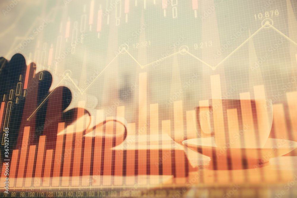 Double exposure of financial chart drawing and desktop with coffee and items on table background. Concept of forex market trading Double exposure of financial chart drawing and desktop with coffee and items on table background. Concept of forex market trading