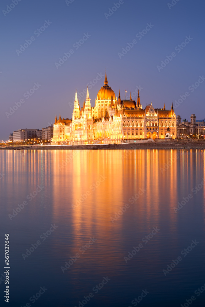 Hungarian Parliament in Budapest reflecting in water. Night view