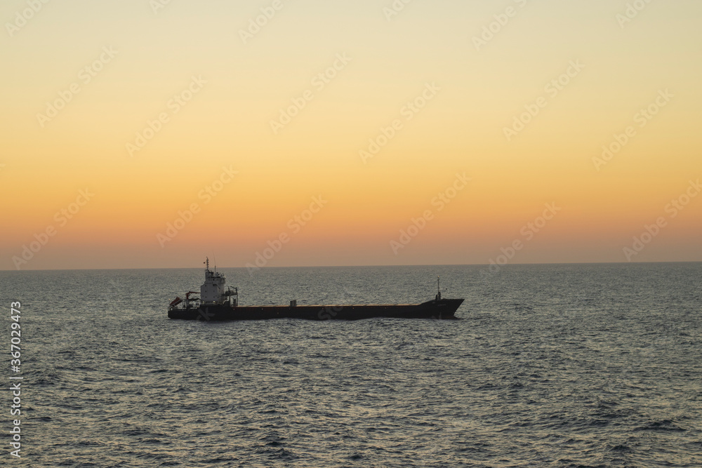 cargo ship going at sunset cargo ship going at sunset