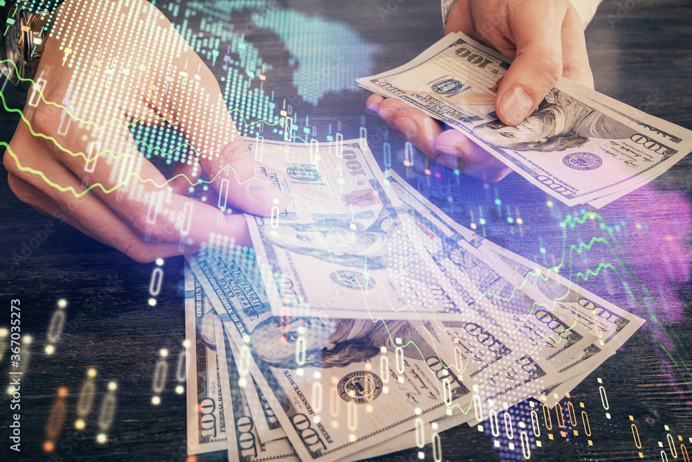 Multi exposure of financial graph drawing hologram and USA dollars bills and man hands. Analysis concept. Multi exposure of financial graph drawing hologram and USA dollars bills and man hands. Analysis concept.