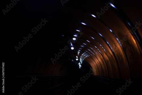 Tunnel in the dark. Low lighting in a spherical corridor.