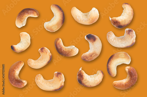 Cashews pattern on a orange background. Nuts creative layout. Top view